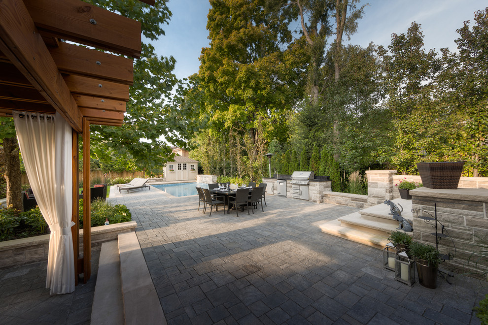 Large trendy backyard stamped concrete patio photo in Toronto with a gazebo