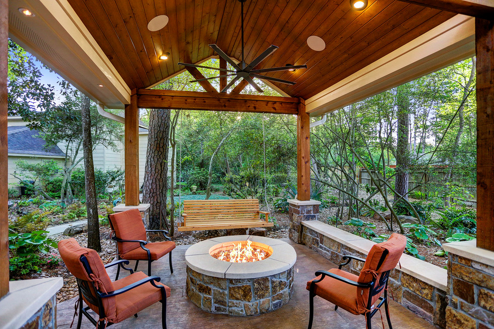 Medium sized rustic back patio in Houston with stamped concrete, a gazebo and a fire feature.