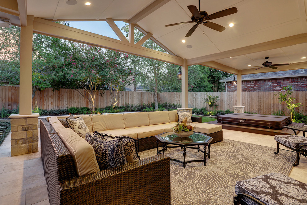 Photo of a medium sized classic back patio in Houston with a fire feature, tiled flooring and a roof extension.