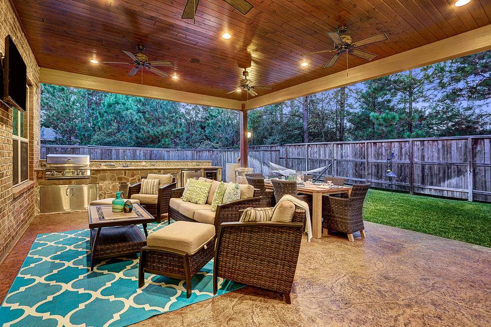 Inspiration for a medium sized classic back patio in Houston with a fire feature, stamped concrete and a roof extension.