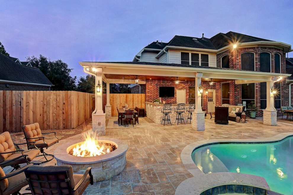 Medium sized traditional back patio in Houston with an outdoor kitchen, tiled flooring and a roof extension.
