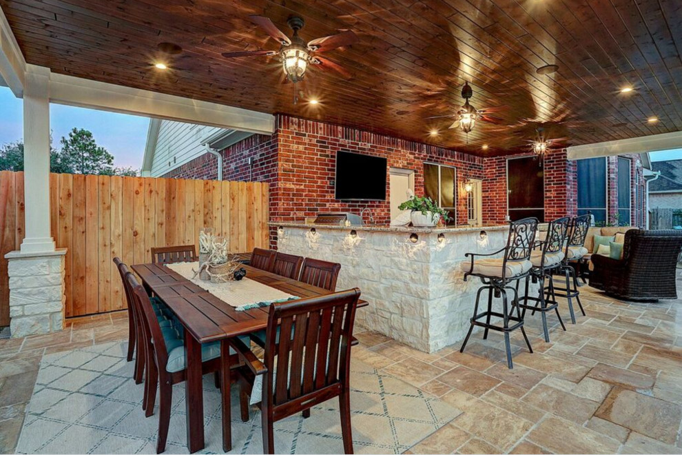 Inspiration for a mid-sized timeless backyard tile patio kitchen remodel in Houston with a roof extension