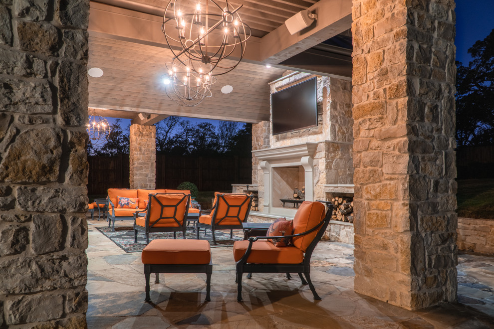 Inspiration for a large backyard stone patio remodel in Dallas with a fireplace and a gazebo