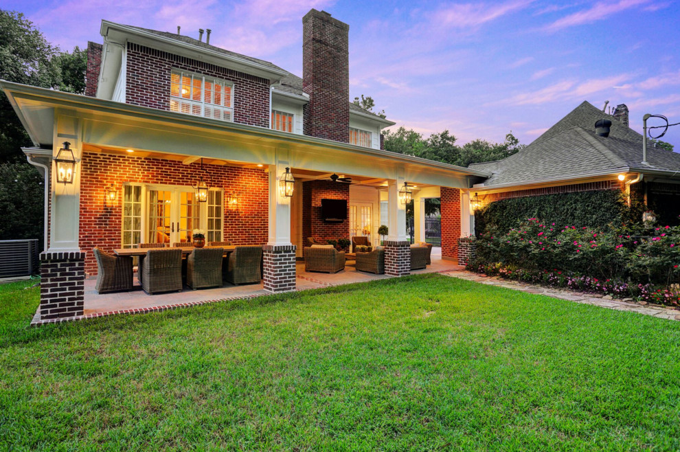 Inspiration for a mid-sized timeless backyard stamped concrete patio remodel in Houston with a roof extension