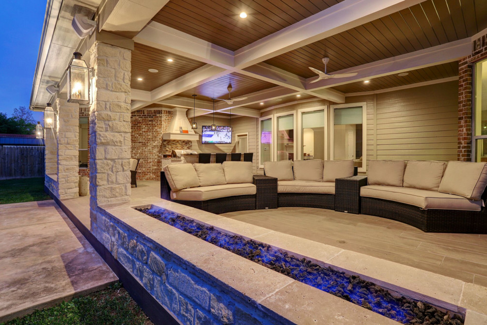 Mid-sized transitional backyard stone patio kitchen photo in Houston with a roof extension
