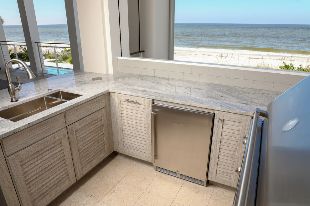 Beach style backyard patio kitchen photo in Tampa with a roof extension