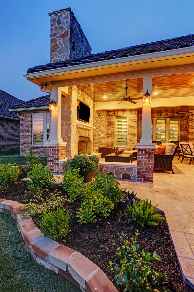 Inspiration for a large transitional backyard stone patio kitchen remodel in Houston with a roof extension