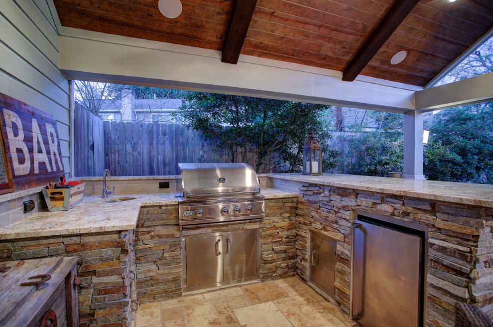 Mid-sized elegant backyard patio kitchen photo in Houston with a roof extension