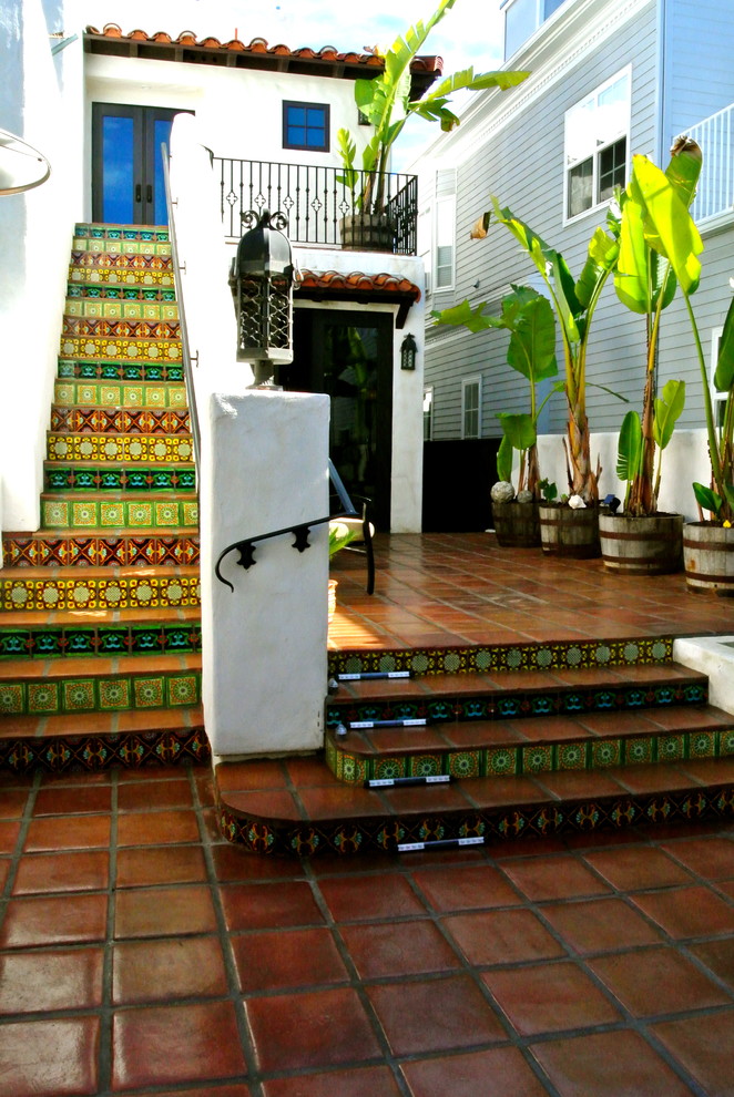 Design ideas for a mediterranean patio steps in San Diego with tiled flooring and no cover.