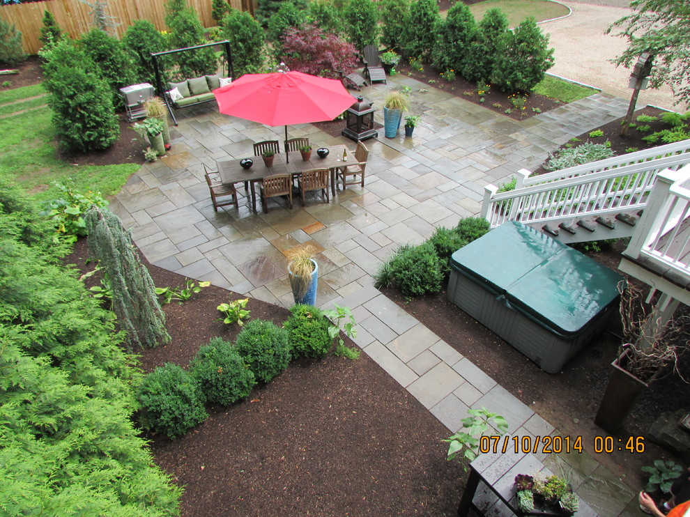 Photo of a large traditional back patio in Bridgeport with a fire feature, stamped concrete and no cover.