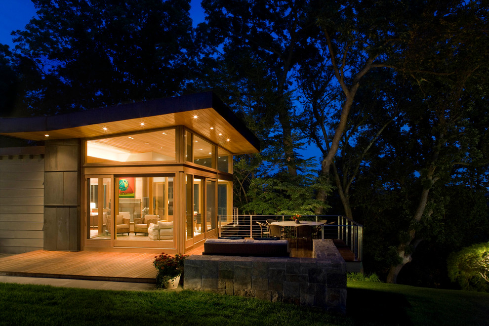 Inspiration for a large contemporary front yard patio remodel in New York with decking and a roof extension
