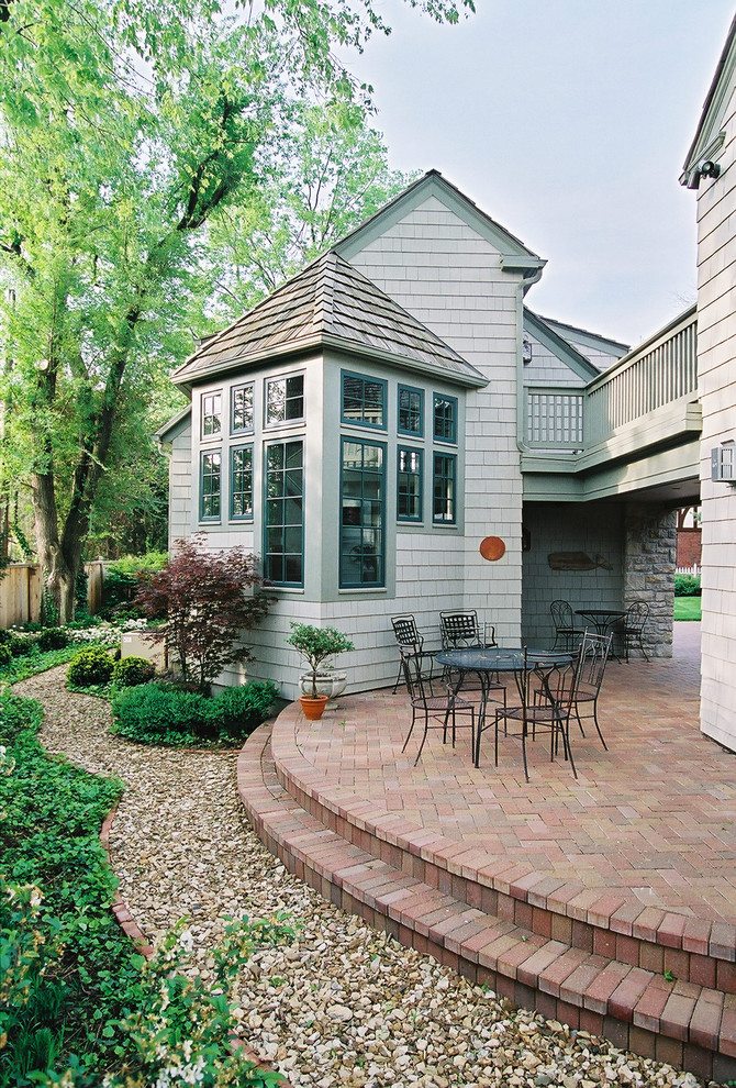 Large classic side patio in Kansas City with brick paving and no cover.