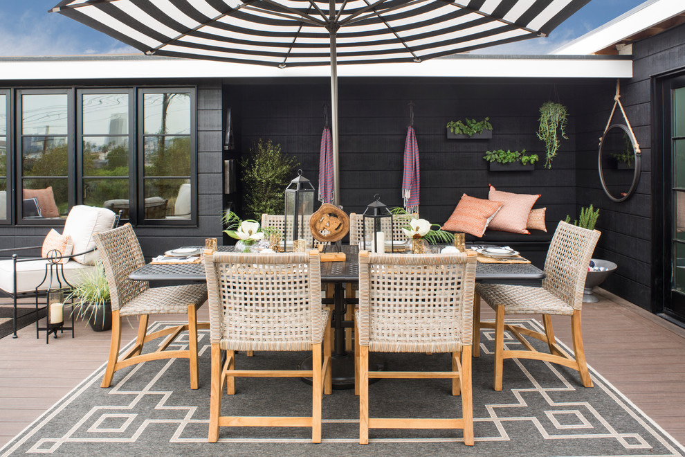 Inspiration for a large transitional backyard patio remodel in Los Angeles with decking and an awning