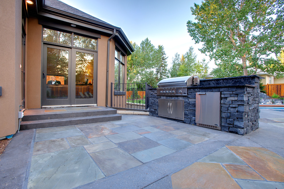 Inspiration for a mid-sized timeless backyard patio kitchen remodel in Calgary with no cover