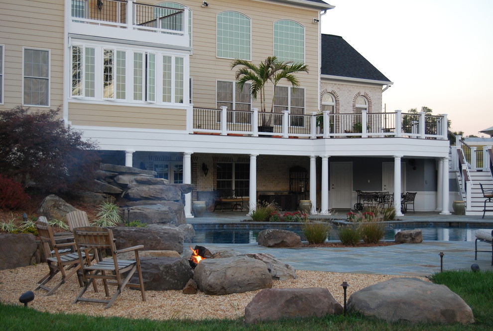 Modelo de patio tradicional extra grande en patio trasero con adoquines de piedra natural