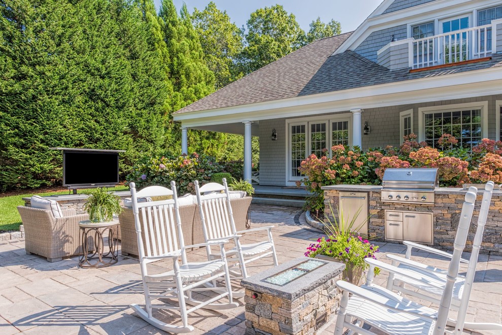 Imagen de patio clásico de tamaño medio sin cubierta en patio trasero con adoquines de hormigón