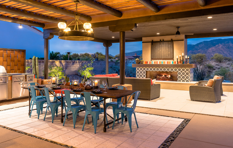 Example of a mid-sized southwest backyard concrete paver patio design in Phoenix with a gazebo and a fireplace