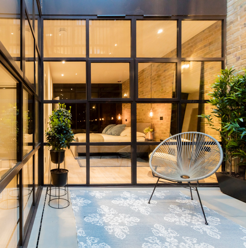 Patio - mid-sized industrial patio idea in London