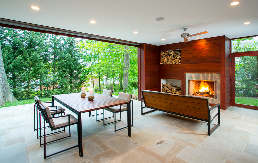 Photo of a large contemporary back patio in DC Metro with a fire feature, concrete paving and a roof extension.