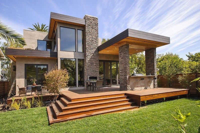Cette image montre une terrasse arrière design avec une cuisine d'été et une extension de toiture.