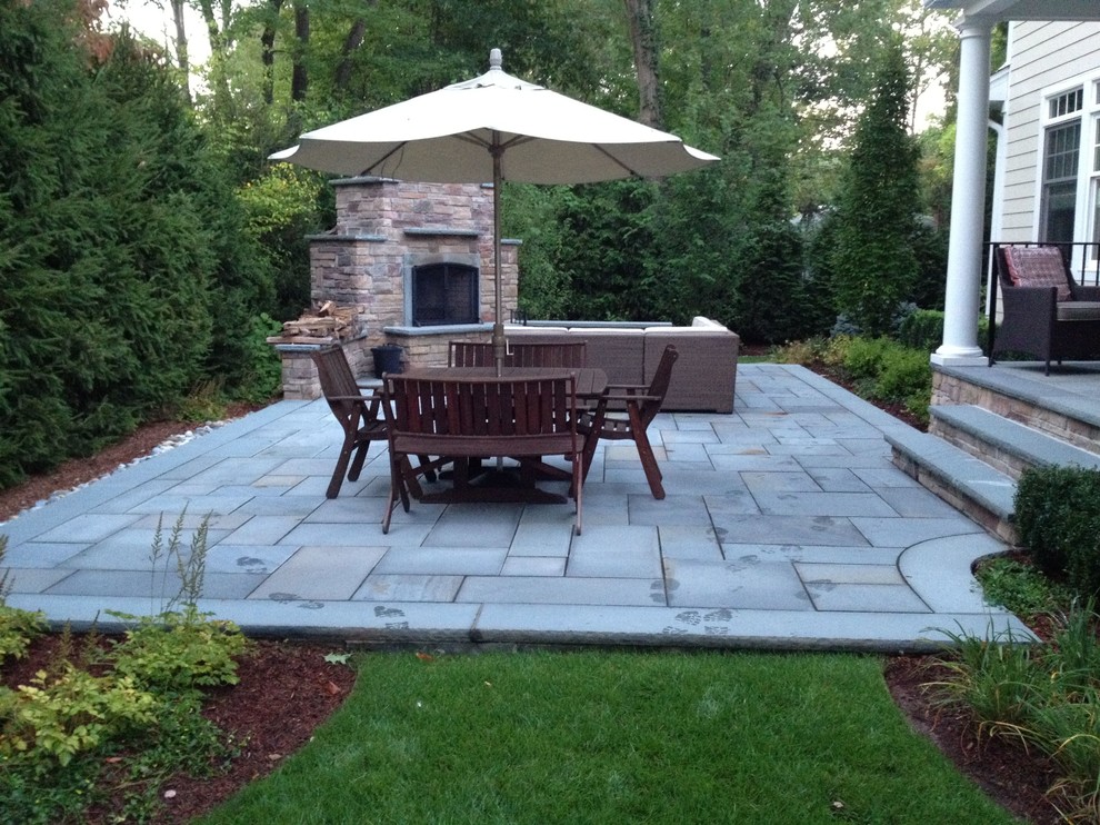 Raised Bluestone Patio with Fireplace and Landscaping Traditional