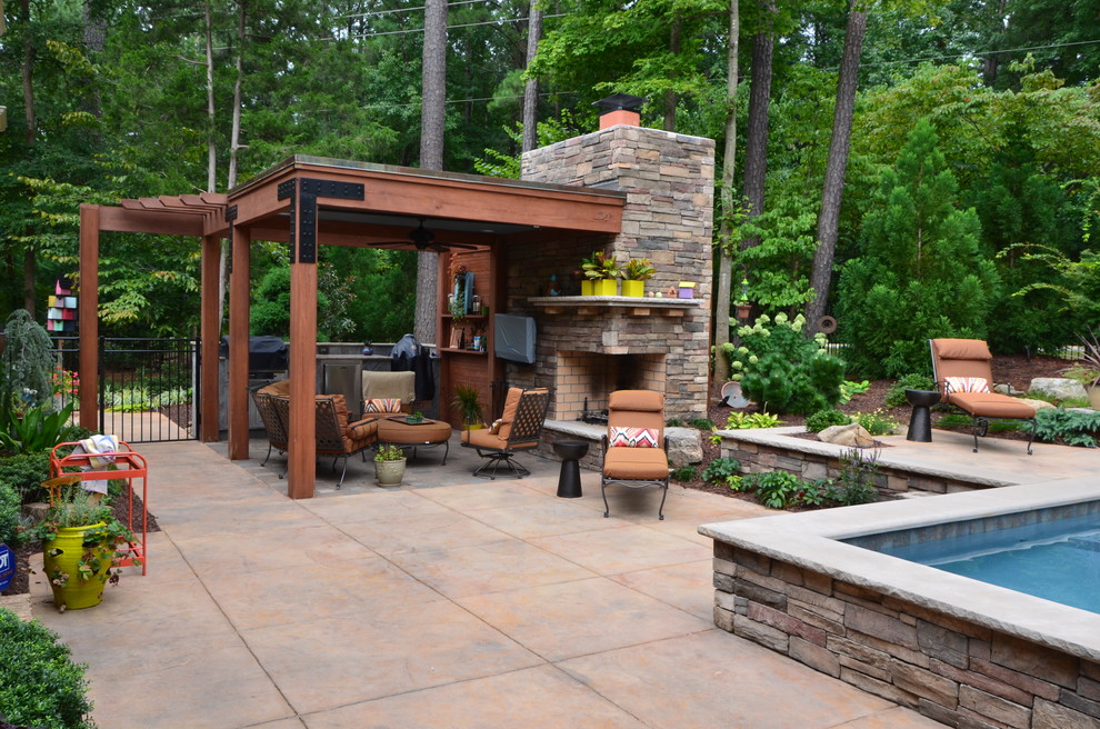 This is an example of a medium sized traditional back patio in Raleigh with an outdoor kitchen, concrete paving and a gazebo.