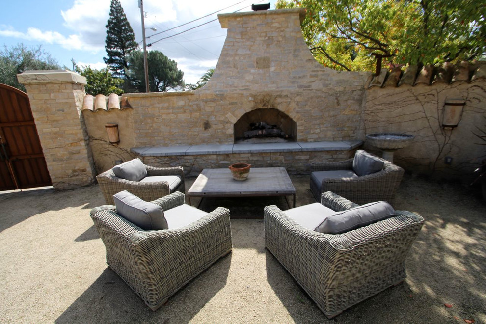 Photo of a mediterranean patio in San Francisco with a fire feature and no cover.