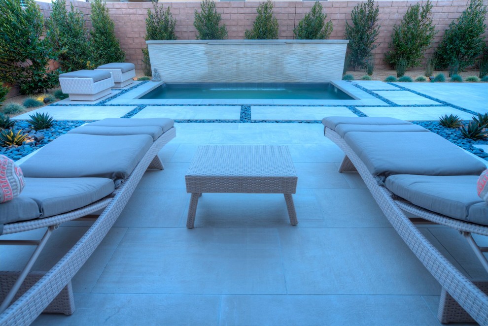 Cette image montre une grande terrasse arrière design avec une dalle de béton et aucune couverture.