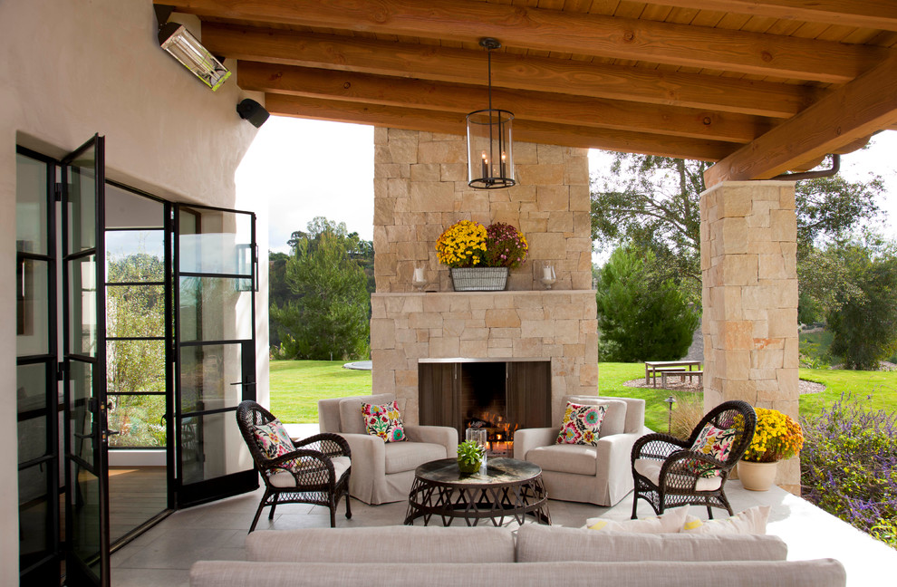 Tuscan patio photo in San Diego with a fire pit and a roof extension