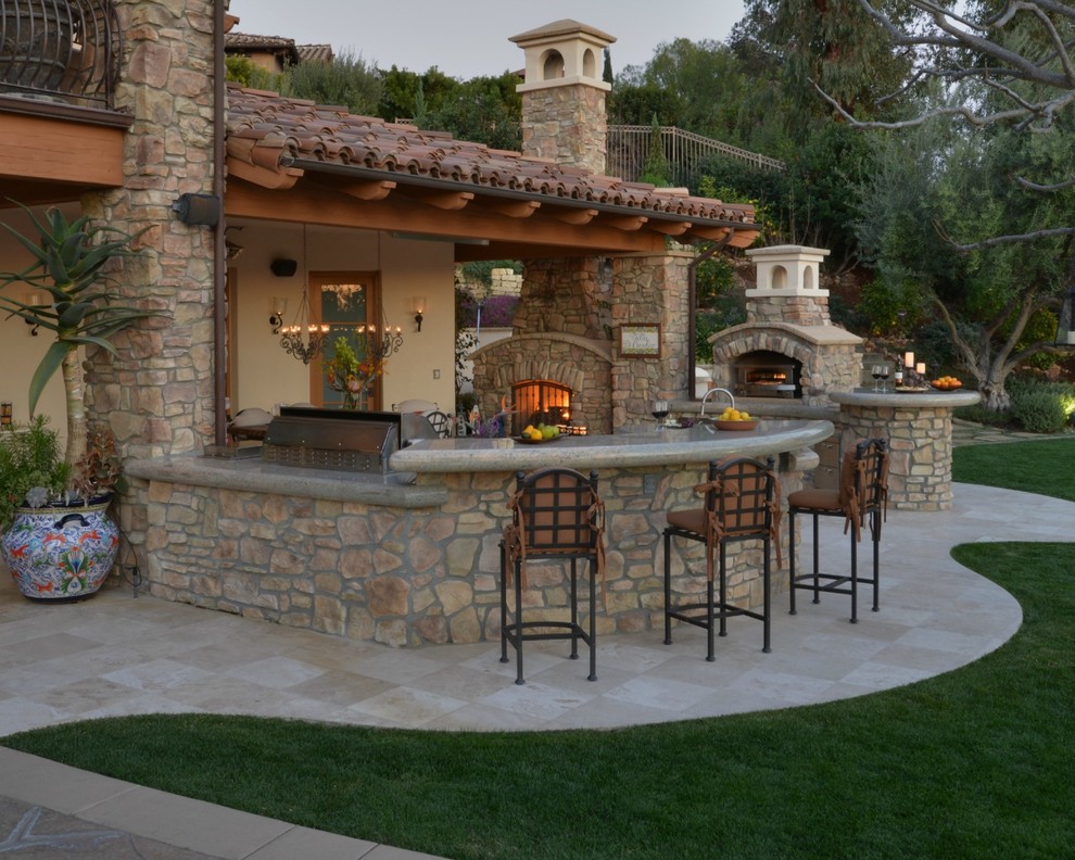 Photo of a large mediterranean back patio in San Diego with an outdoor kitchen and tiled flooring.