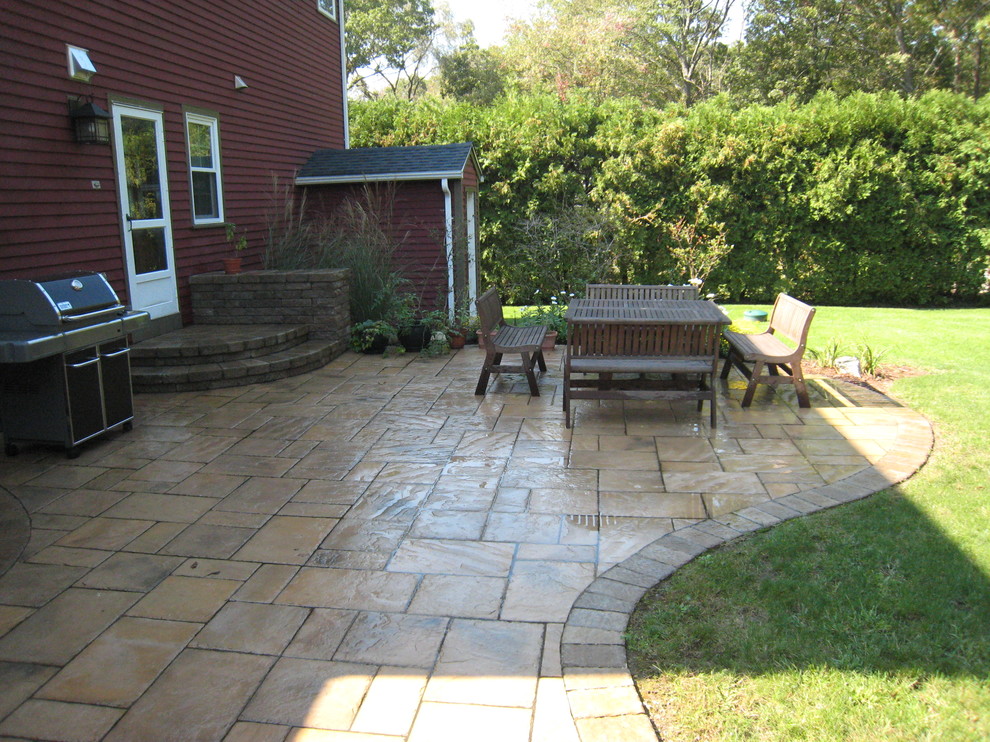 Large traditional back patio in Providence with no cover.