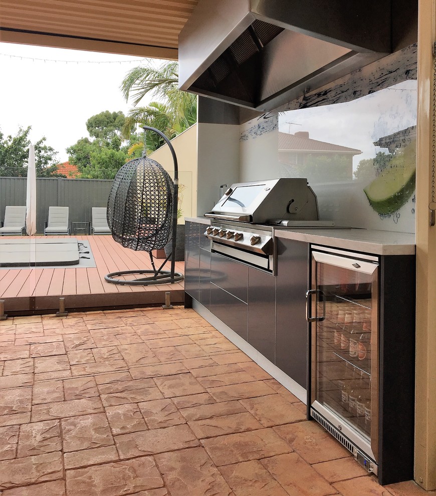 Medium sized modern back patio in Melbourne with an outdoor kitchen, decking and a roof extension.