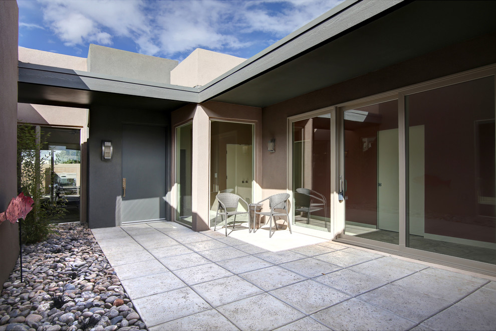 Inspiration for a mid-sized contemporary courtyard tile patio remodel in Albuquerque with no cover