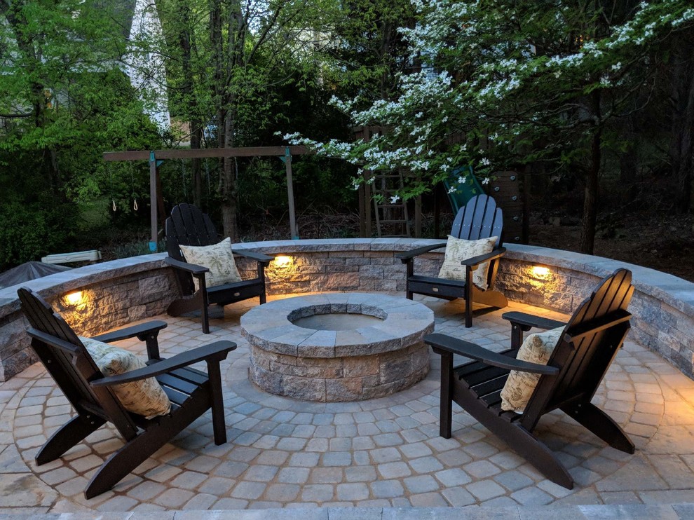 Medium sized classic back patio in Raleigh with a fire feature, concrete paving and no cover.