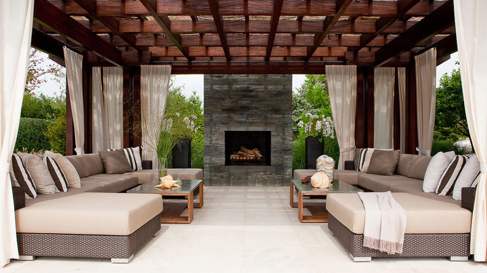 Design ideas for a contemporary patio in New York with a pergola and a fireplace.