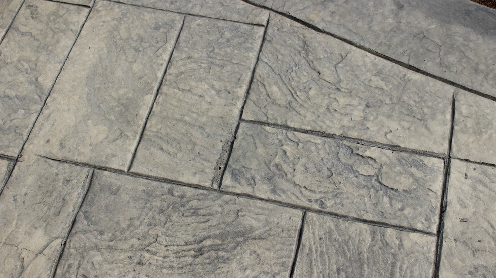 Inspiration for a mid-sized contemporary backyard stamped concrete patio remodel in Kansas City with no cover