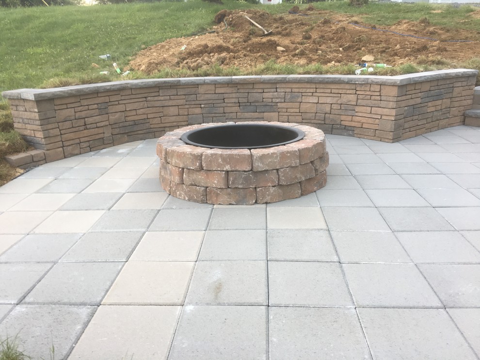 Photo of a medium sized rural side patio in Other with a fire feature and concrete paving.