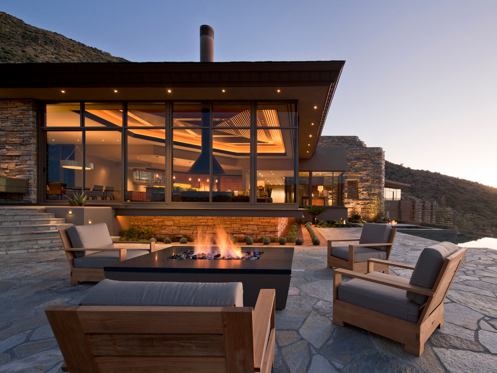 Design ideas for a contemporary patio in Phoenix with a fire feature.