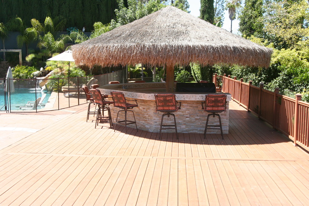 Inspiration for a large tropical backyard patio kitchen remodel in Los Angeles with decking and a gazebo