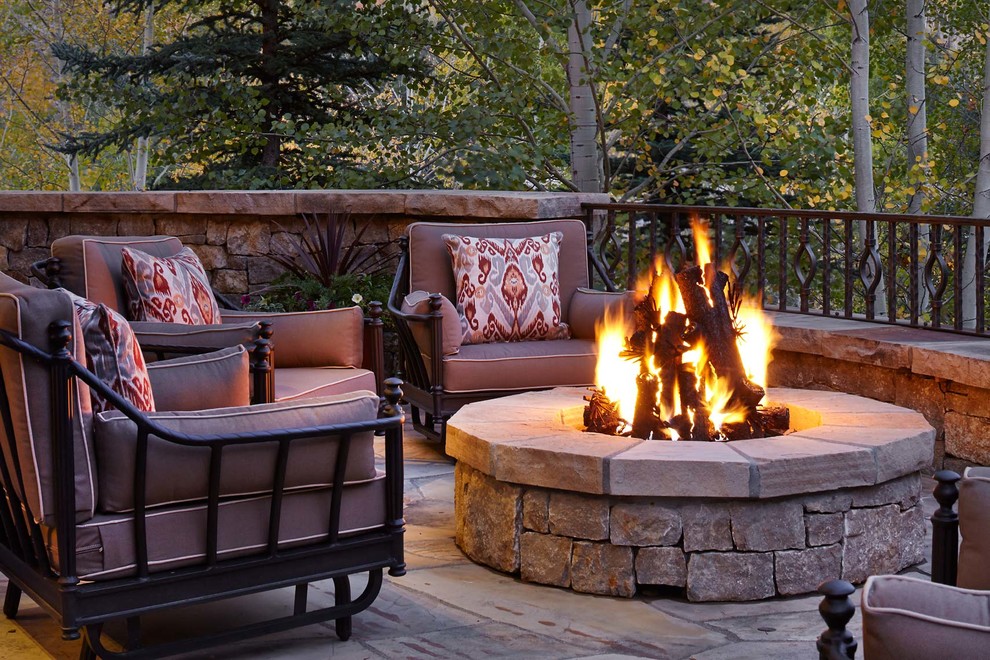 Inspiration for a medium sized rustic back patio in Denver with a fire feature and natural stone paving.