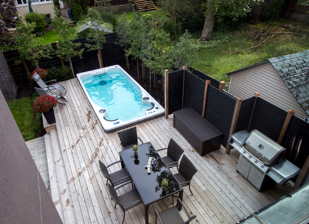 Photo of a medium sized modern back patio in Toronto with decking and no cover.
