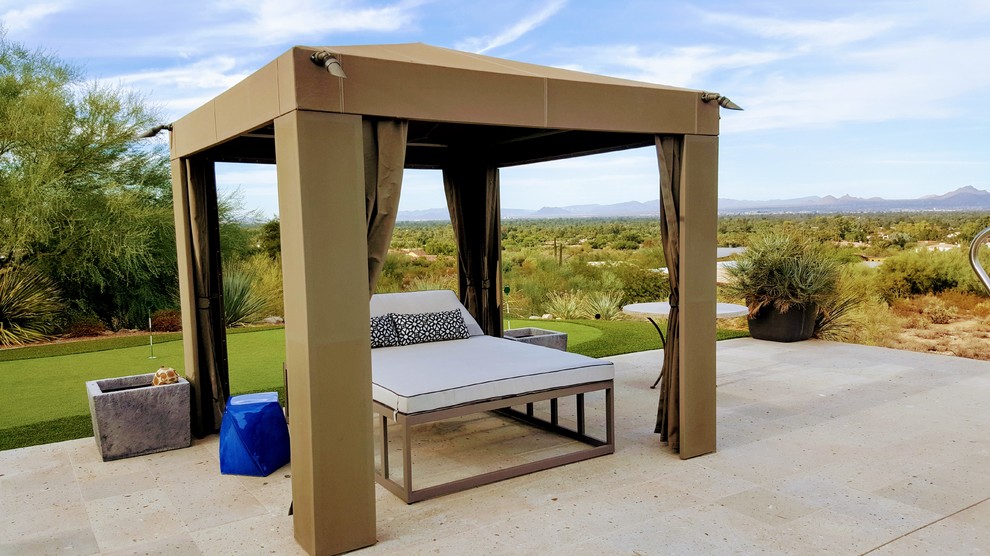 Medium sized traditional back patio in Phoenix with tiled flooring and an awning.