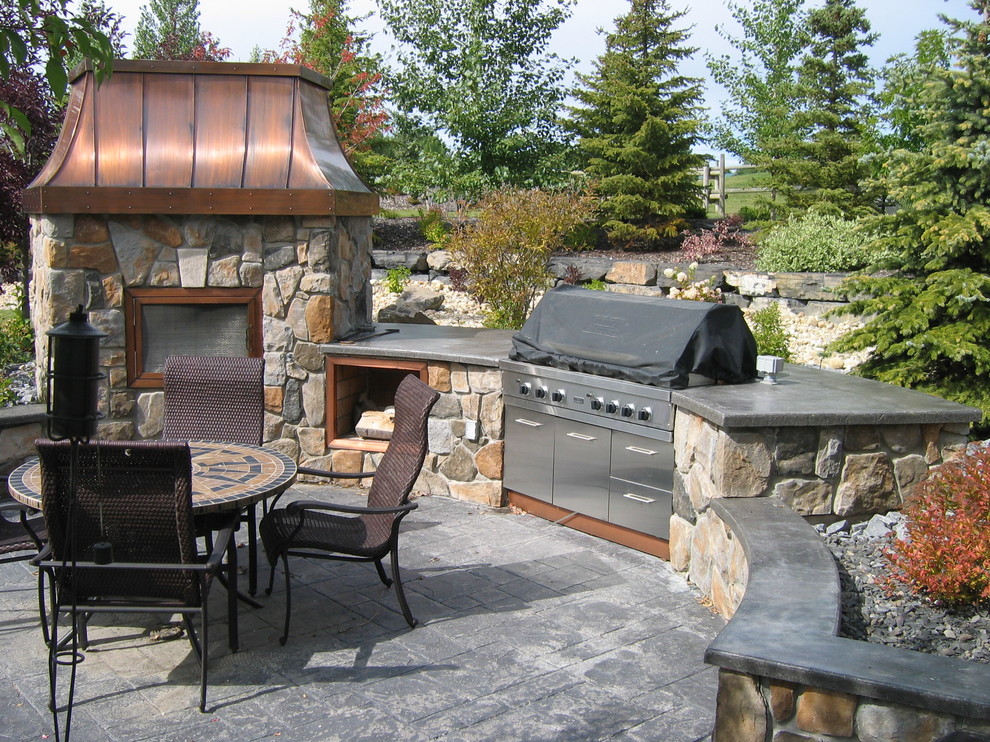 Large elegant backyard patio kitchen photo in Calgary