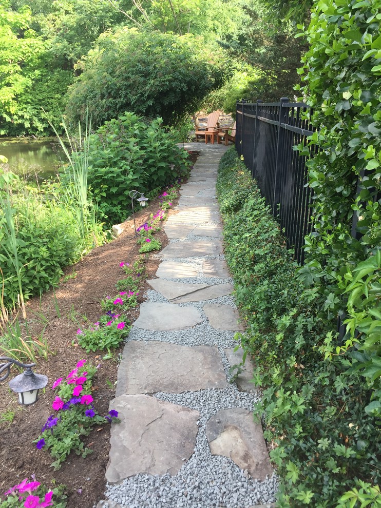 Photo of a medium sized rustic back garden in New York with natural stone paving.