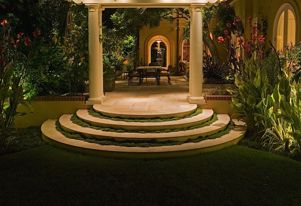 This is an example of a large world-inspired back patio in San Francisco with tiled flooring and a pergola.