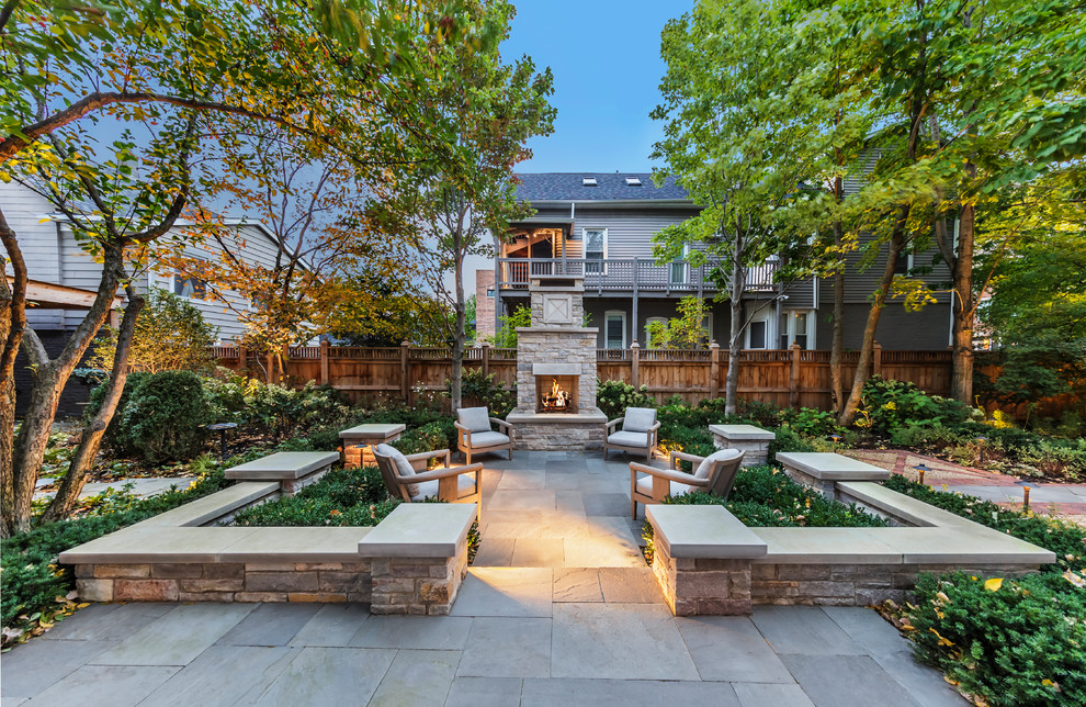 Classic back patio in Chicago with no cover and a fireplace.