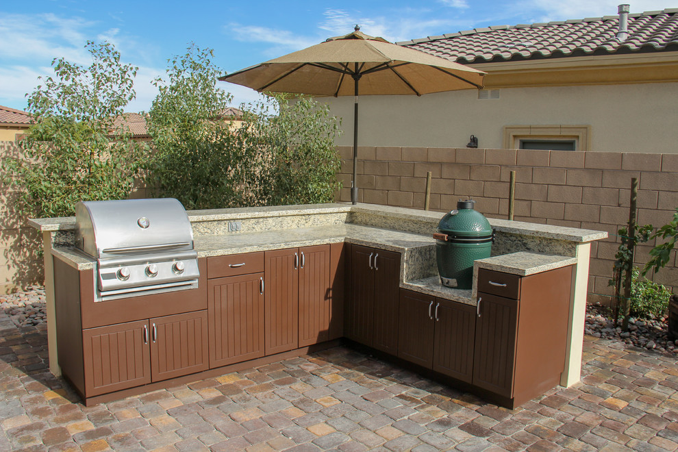 Mid-sized elegant backyard brick patio kitchen photo in Other with no cover