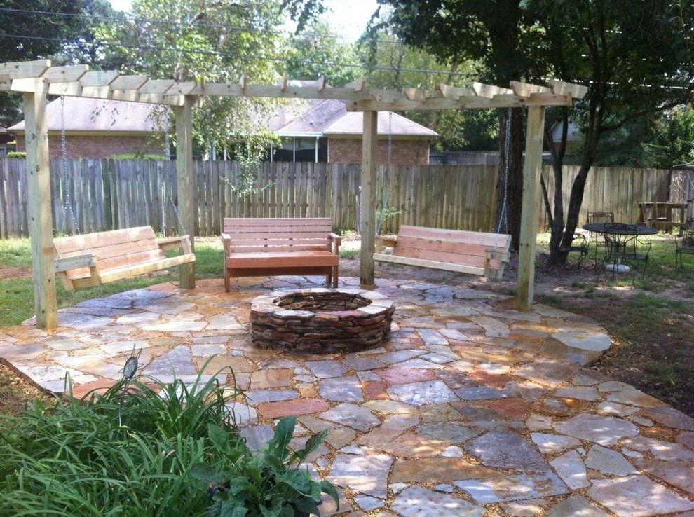 Inspiration for a large timeless backyard stone patio kitchen remodel in Other