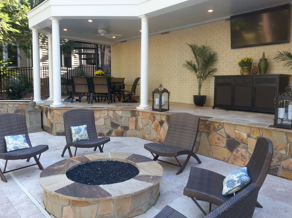 Design ideas for a large classic back patio in Charlotte with natural stone paving, a fire feature and a pergola.