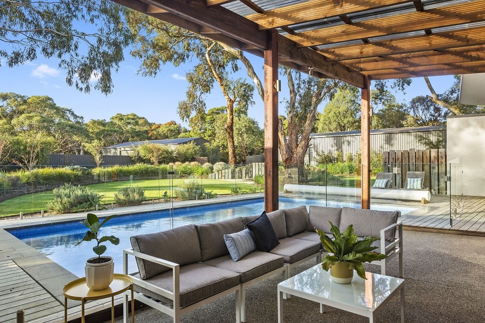 Photo of a contemporary patio in Geelong with concrete slabs and a pergola.